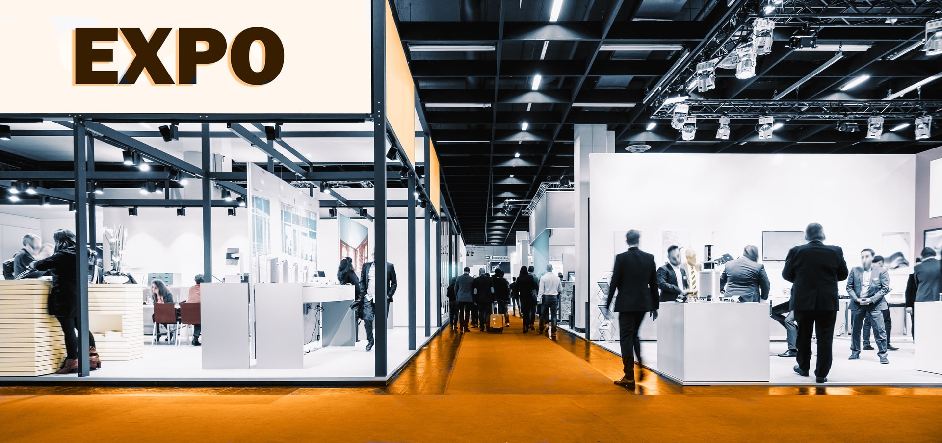 Crowd in front of exhibition stand with banner
